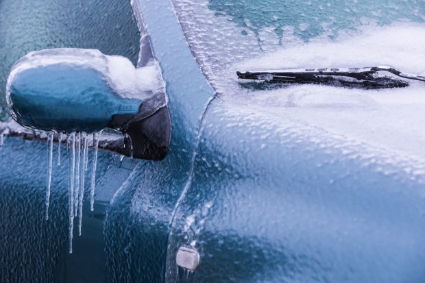 icicles hang from the side mirror of a car