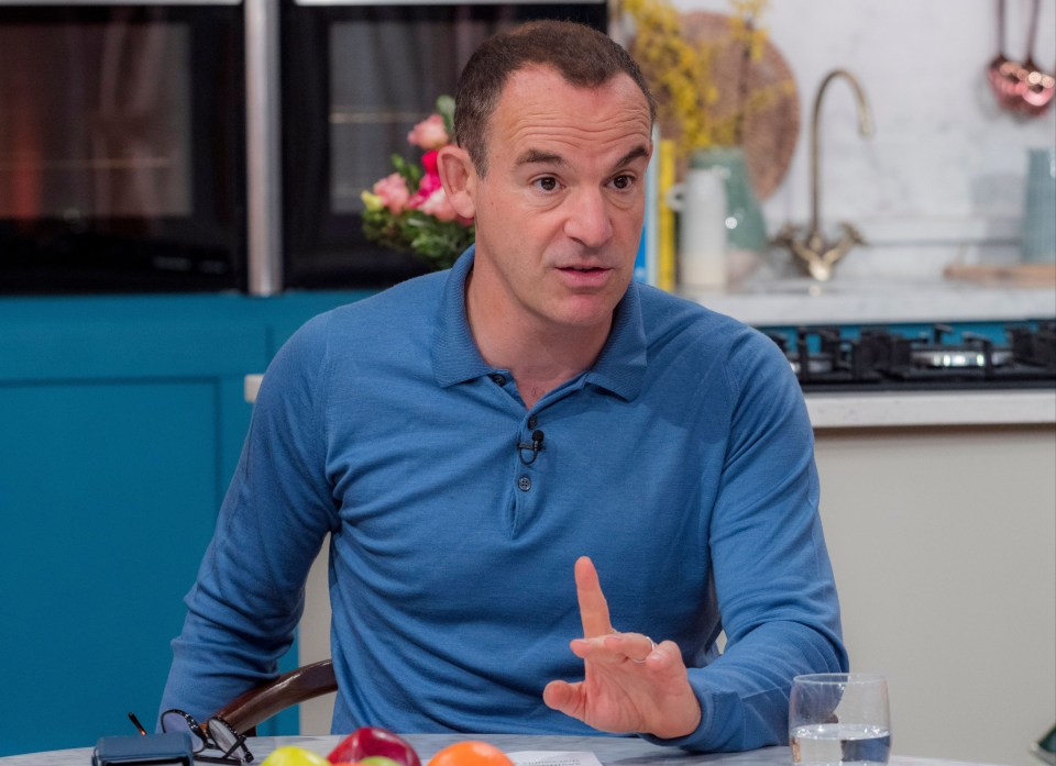 a man in a blue shirt is sitting at a table with fruit