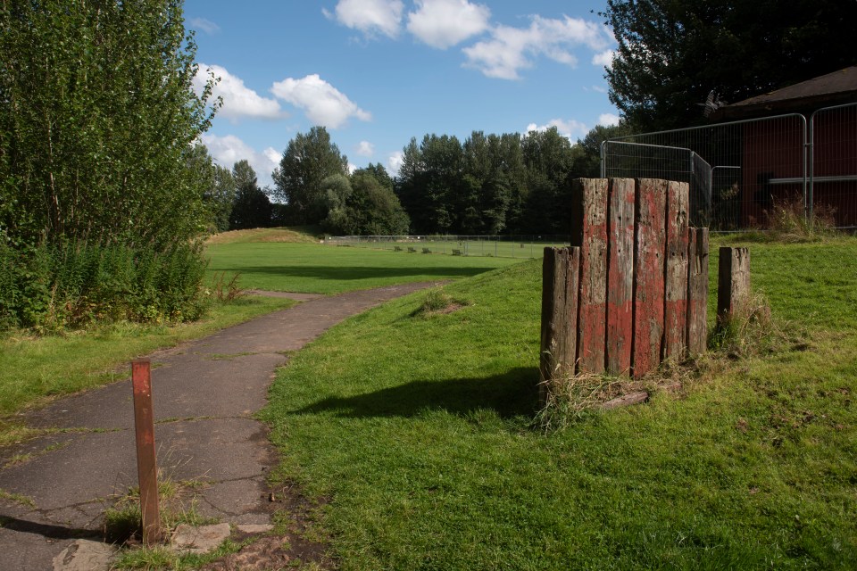 a wooden fence with a red and white stripe painted on it