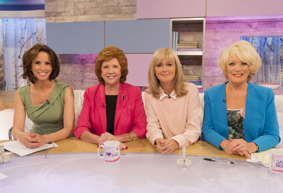 four women sit at a table with a mug that says i love you