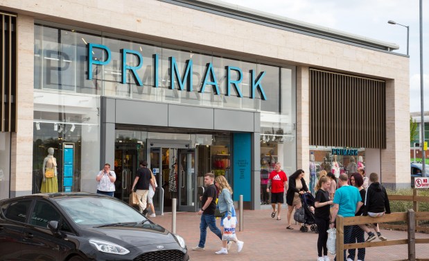 a car is parked in front of a store called primark