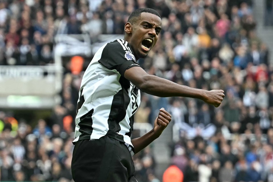 a soccer player in a black and white jersey celebrates