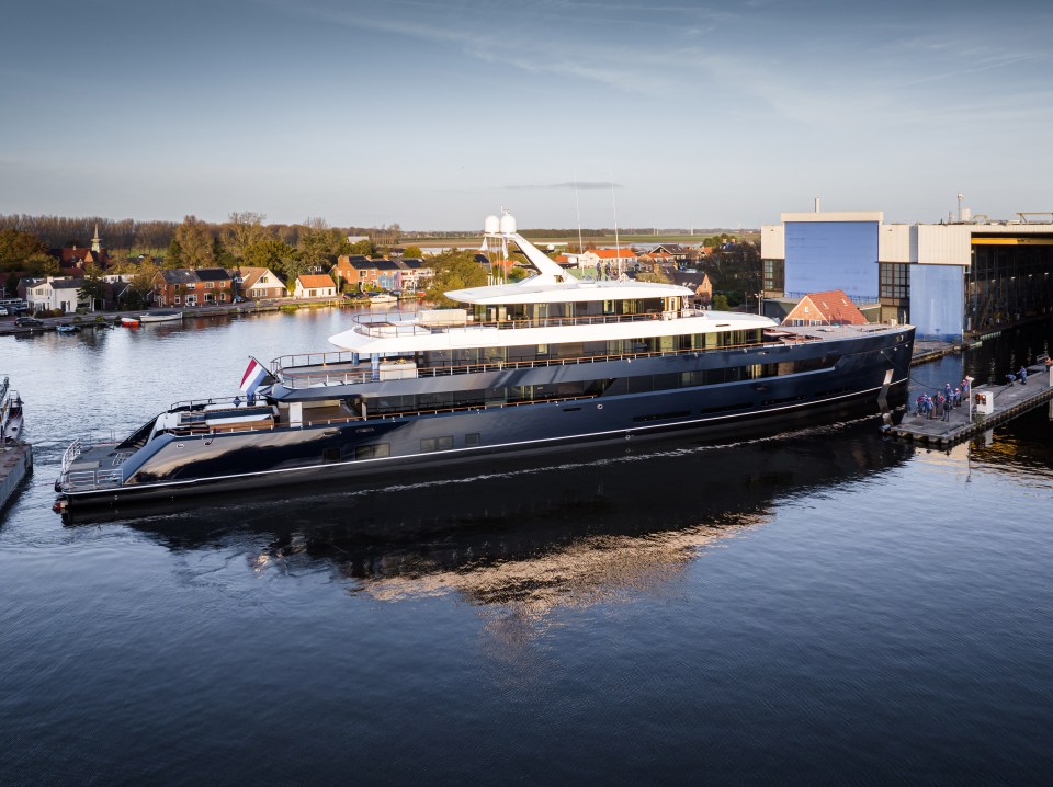 a large yacht is docked at a dock in the water