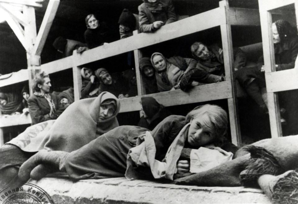 a black and white photo of a group of people laying on a bunk