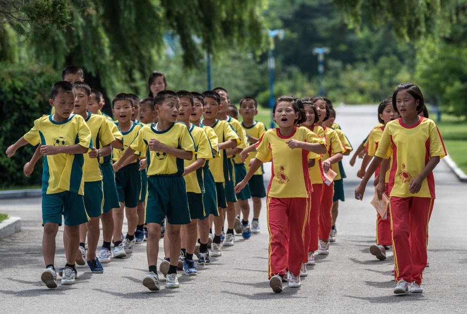 Children sing as they march in formation through Songdowon International School Children’s Camp in Wonsan, North Korea