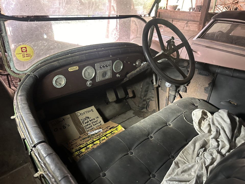 an old car with a note on the seat that says doctor