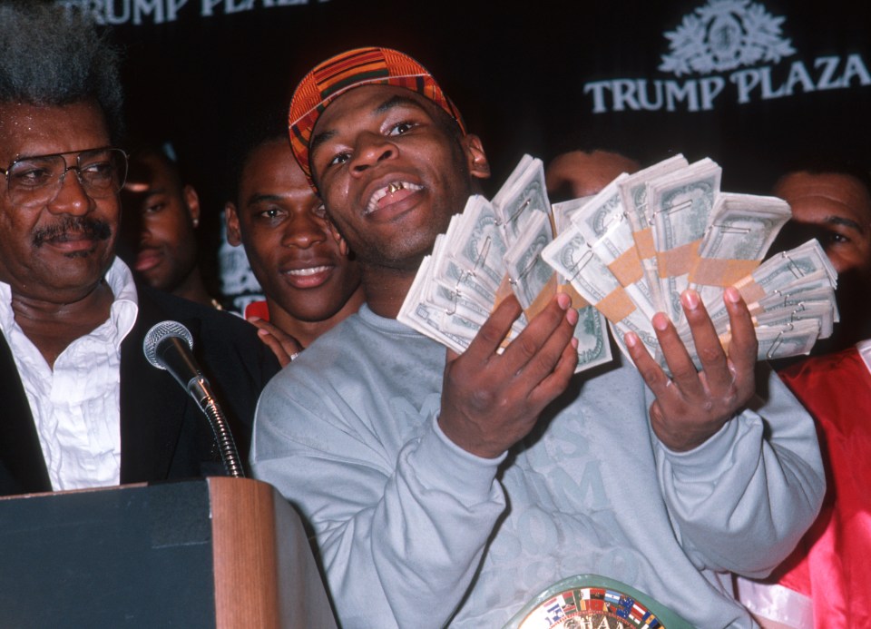 Mike Tyson poses with wads of cash in 1989