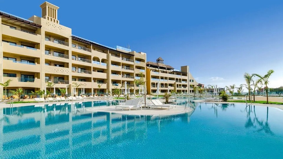 a large building with a swimming pool in front of it