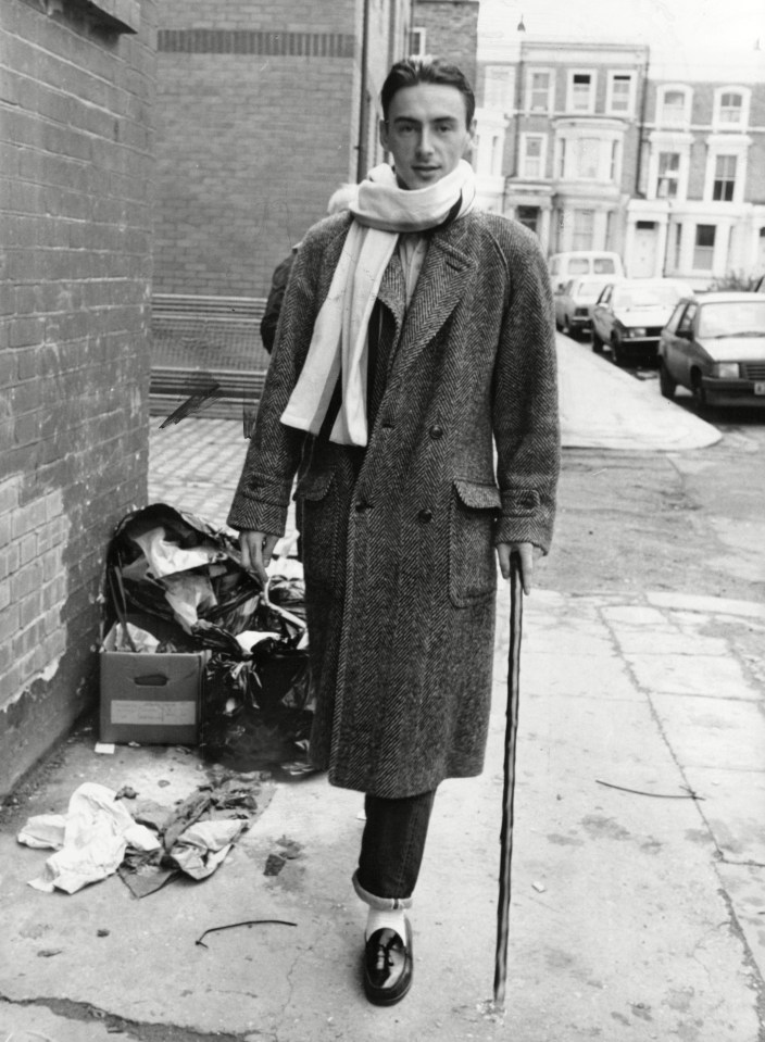 a black and white photo of a man with a cane