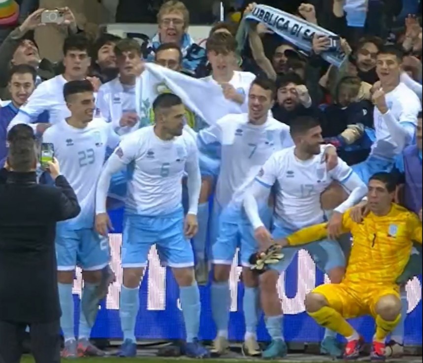 a group of soccer players are posing for a photo in front of a sign that says optus sport