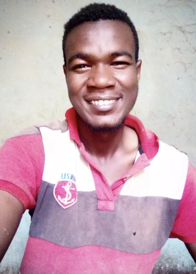 a man wearing a usmc polo shirt smiles for the camera