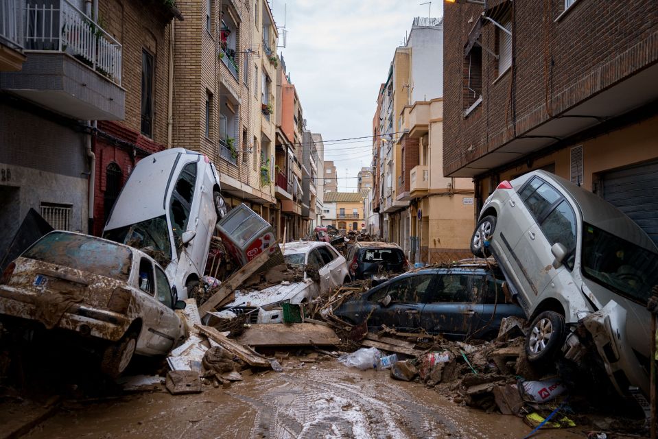 a flooded street with a silver car that has the license plate number aa