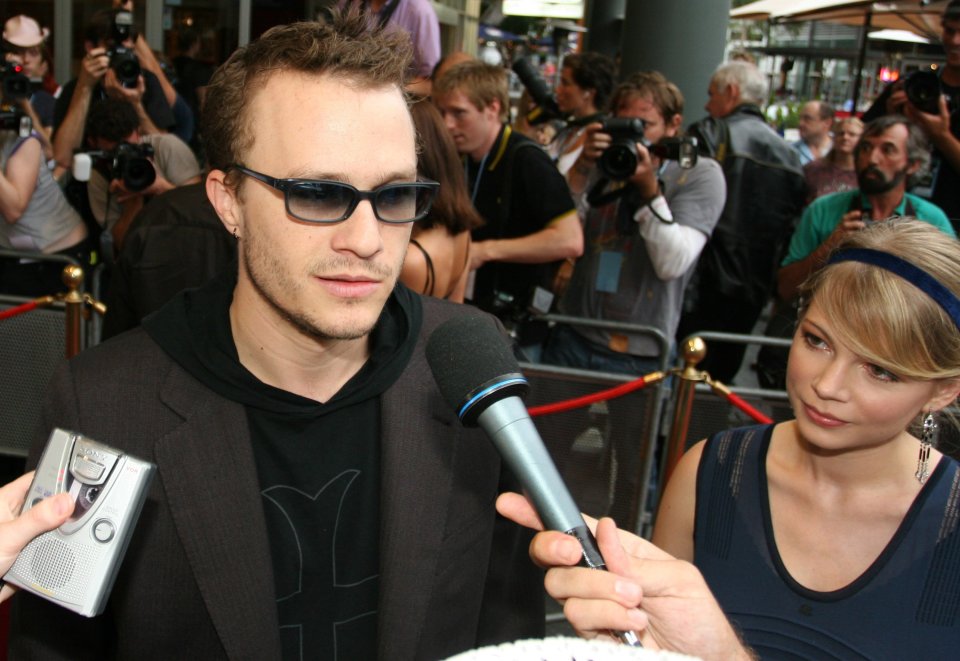 a man wearing sunglasses is being interviewed by a woman