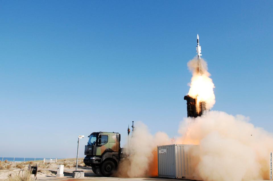 a rocket is being launched from a container and smoke is coming out of it