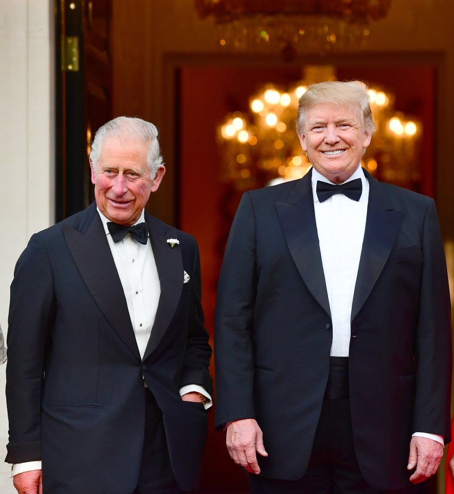 a man in a tuxedo stands next to another man in a tuxedo