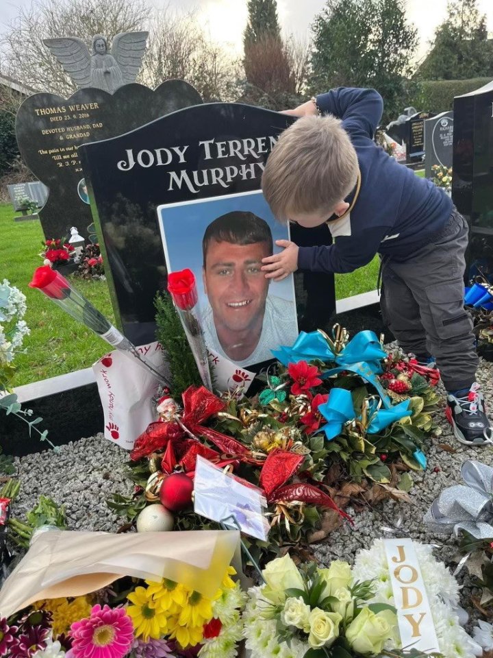 a young boy touches a picture of jody terren murphy