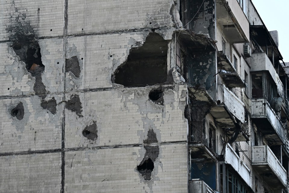 a very old building with holes in it and a few balconies