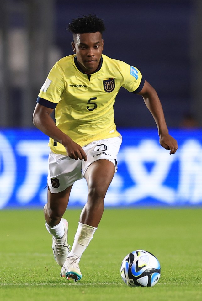 a soccer player wearing a yellow jersey with the number 5 on it