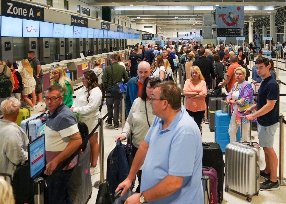 a large group of people are waiting at a check in counter for zone a