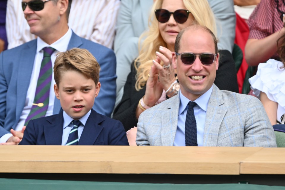 a man wearing sunglasses sits next to a boy wearing a suit