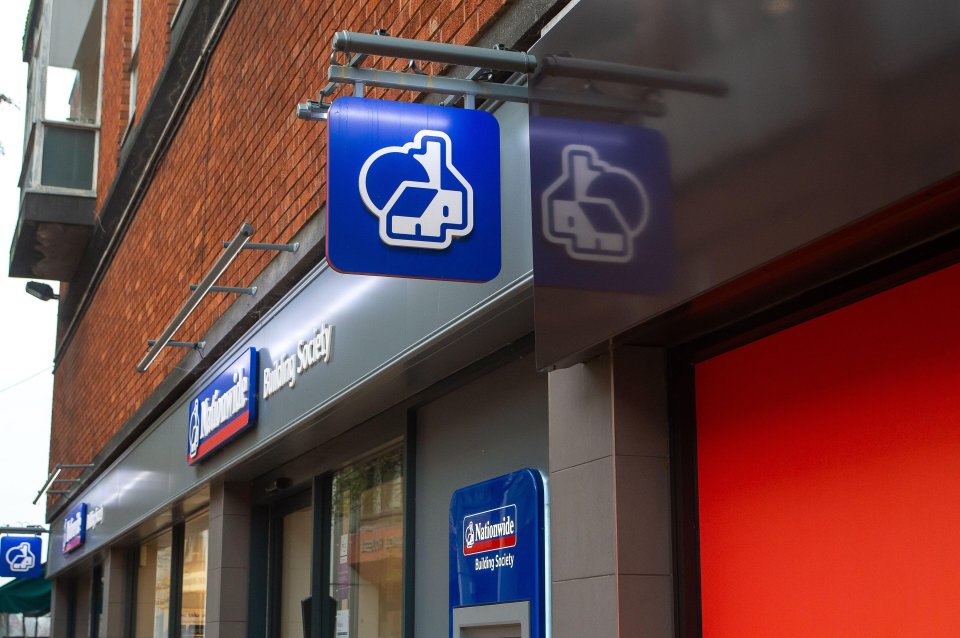 a national savings society sign hangs from the side of a building