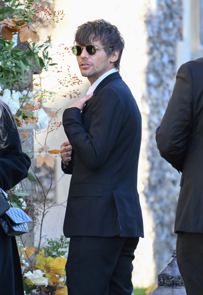 Louis Tomlinson attends the funeral