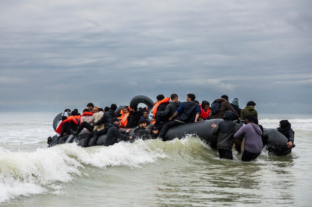 a large group of people are in a boat in the ocean