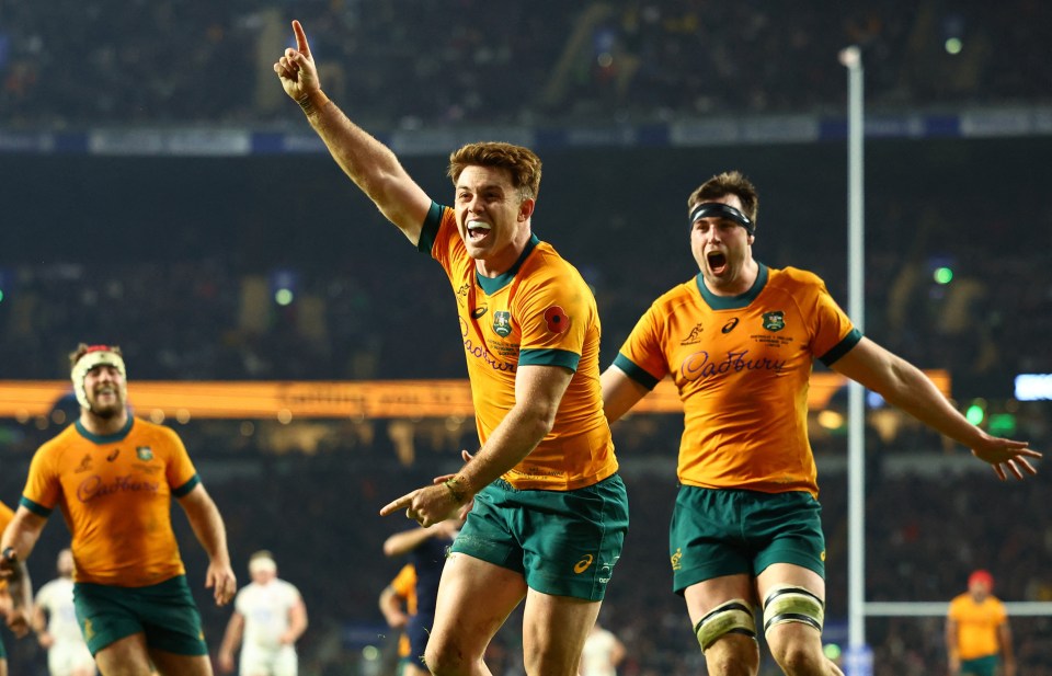 two rugby players are celebrating a try with cadbury on their shirts