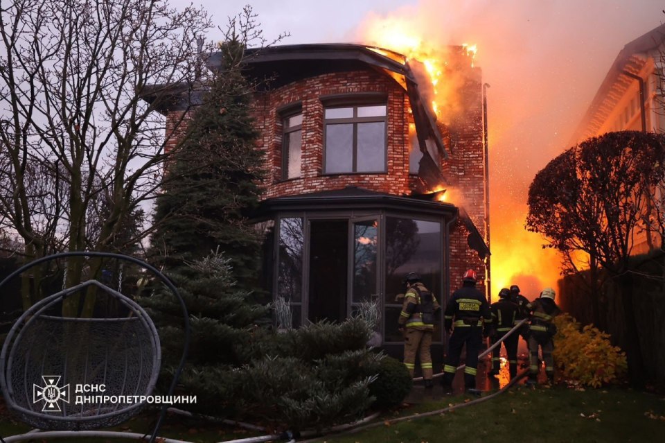 Firefighters work at the site of a Russian missile strike in Dnipro after a suspected ICBM strike