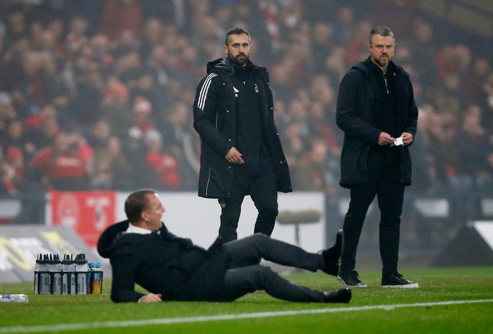 a man is laying on the ground on a soccer field