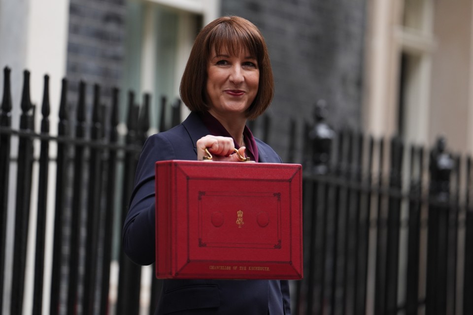 a woman holding a red briefcase that says secretary of the treasury