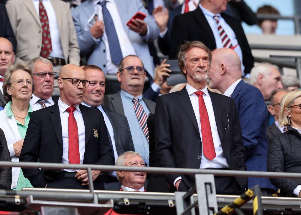 a man in a suit and tie stands in a crowd of people