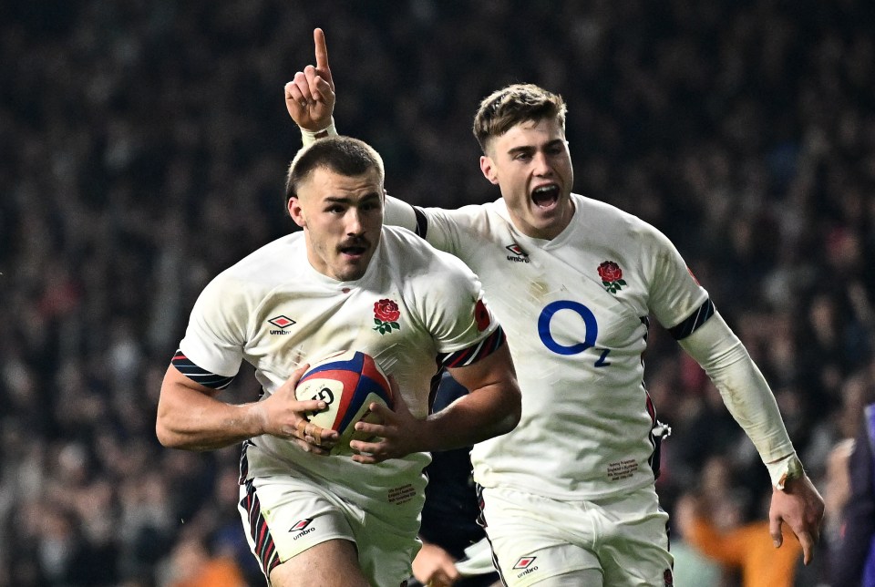 two rugby players wearing jerseys with the letter q on them