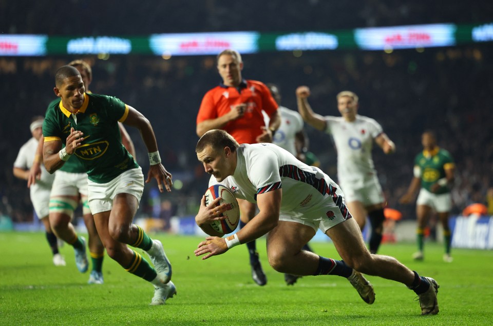 a rugby player wearing a mtn jersey runs with the ball