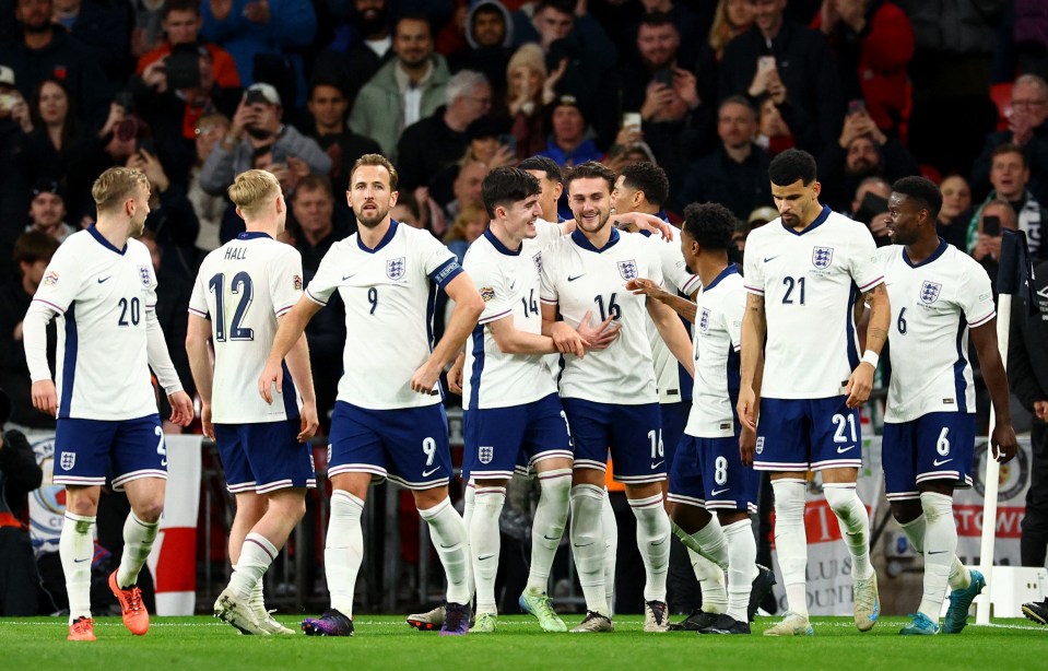 a group of soccer players with one wearing the number 12