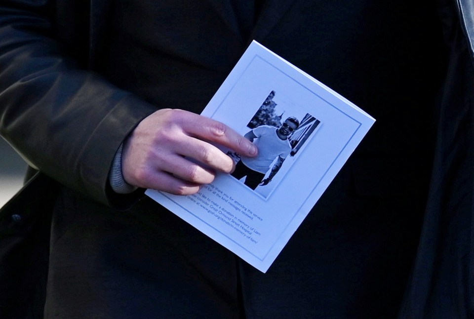 a man is holding a book with a picture of a man on it