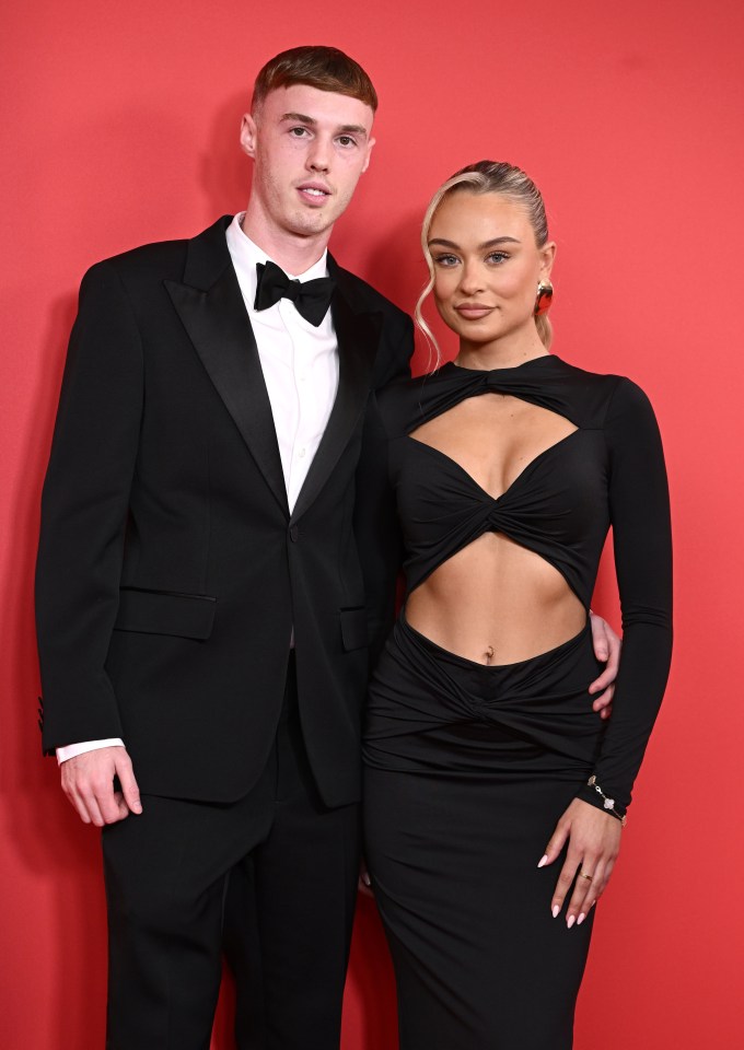 a man in a tuxedo stands next to a woman in a black dress