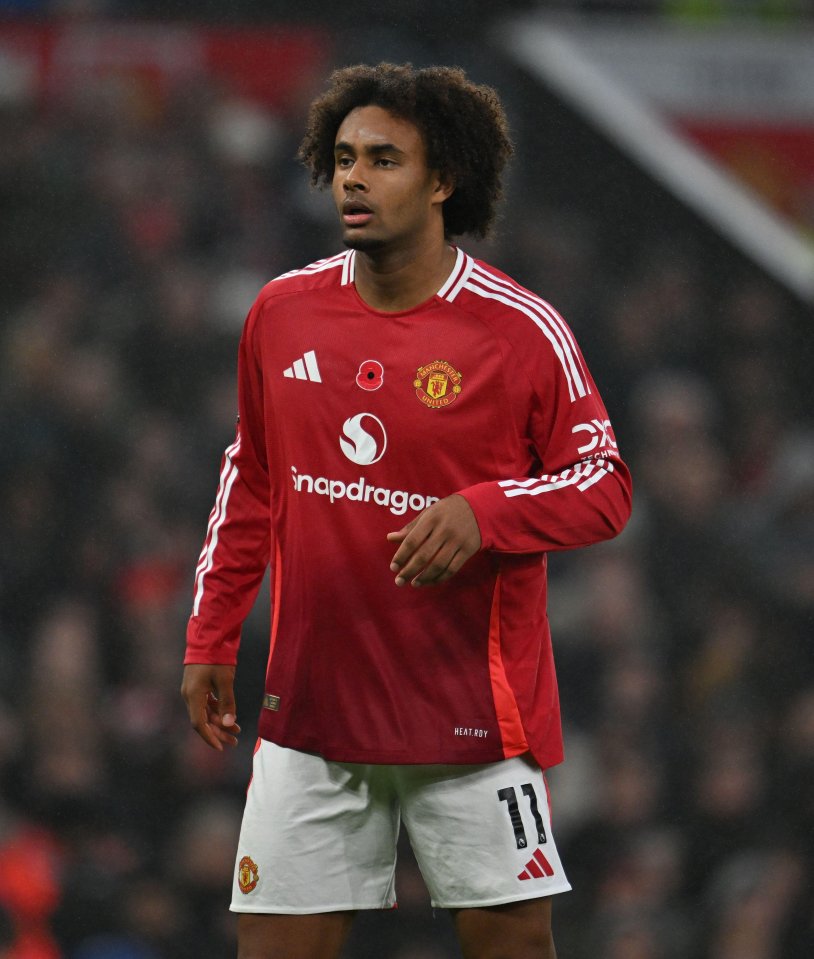 a soccer player wearing a red shirt with the number 11 on his shorts