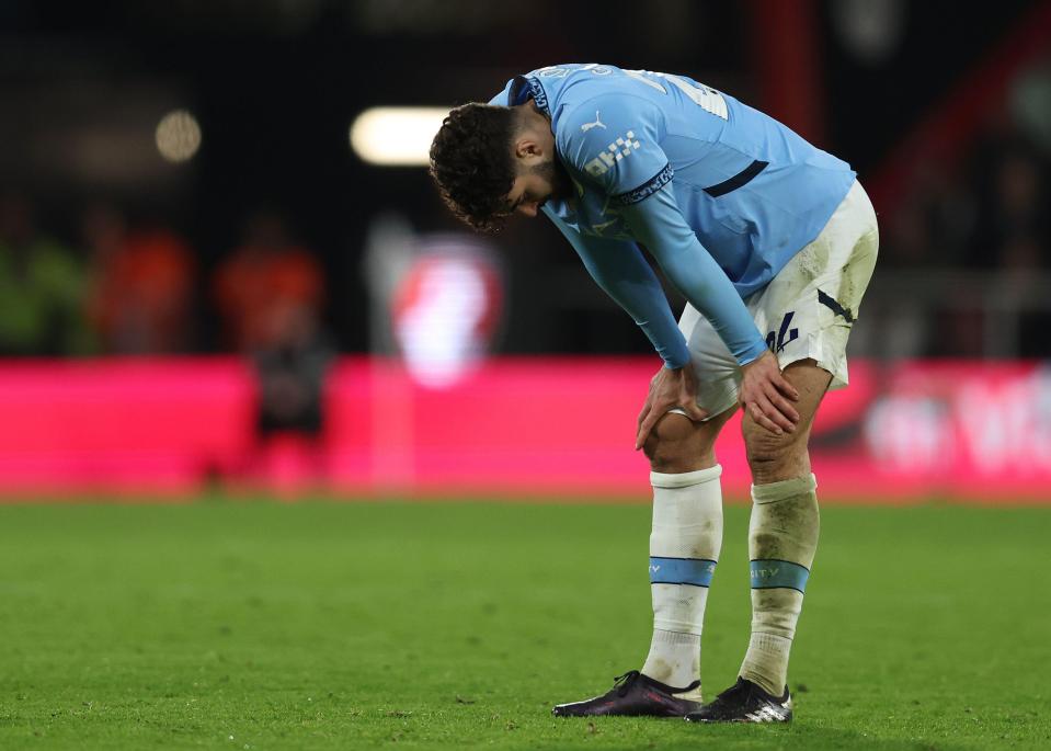 a soccer player wearing a light blue shirt with the word city on it