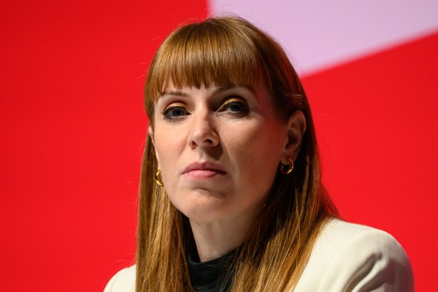 a close up of a woman 's face with a red background