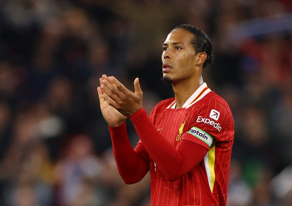 soccer player wearing a red jersey with expedia on the sleeve