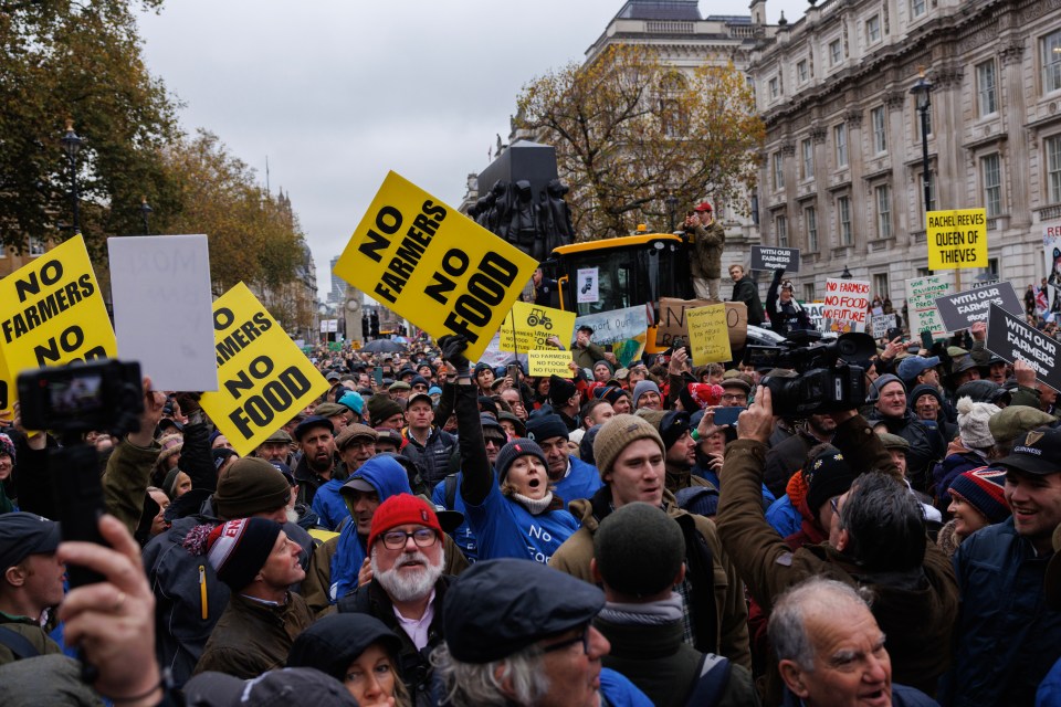 a crowd of people holding signs that say no farmers no food