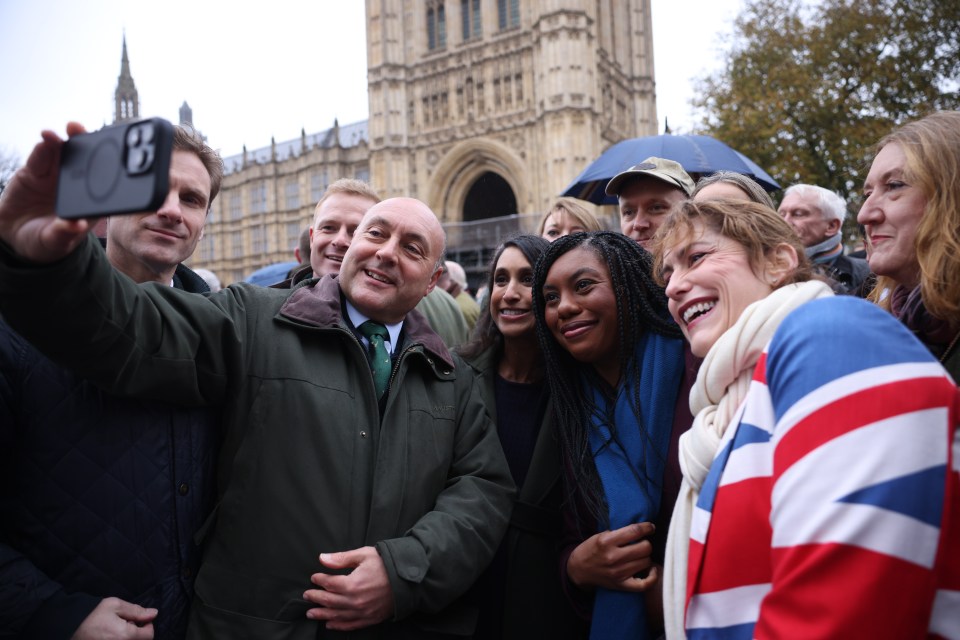 a man taking a selfie with a group of people