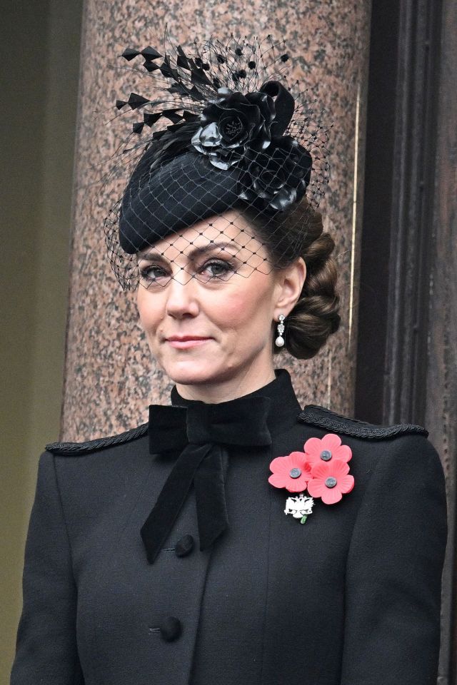 a woman wearing a black hat with a flower on it