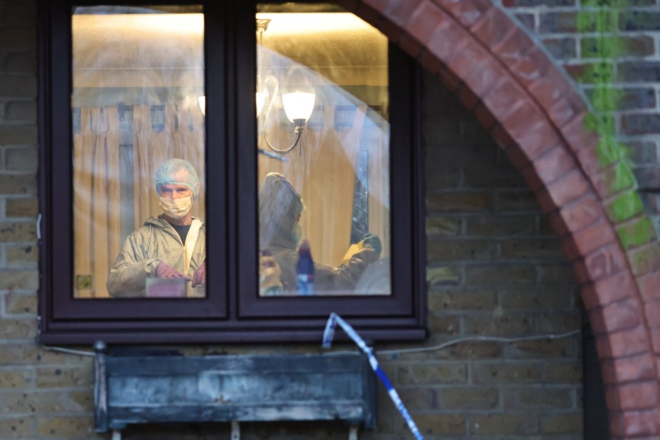 Forensic officers inside the address