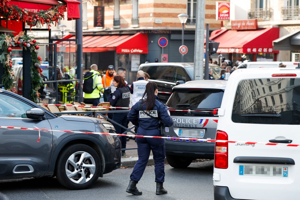 Police officers block the road near the restaurant Pizza L’Olivier in Issy-les-Moulineaux, suburbs of Paris