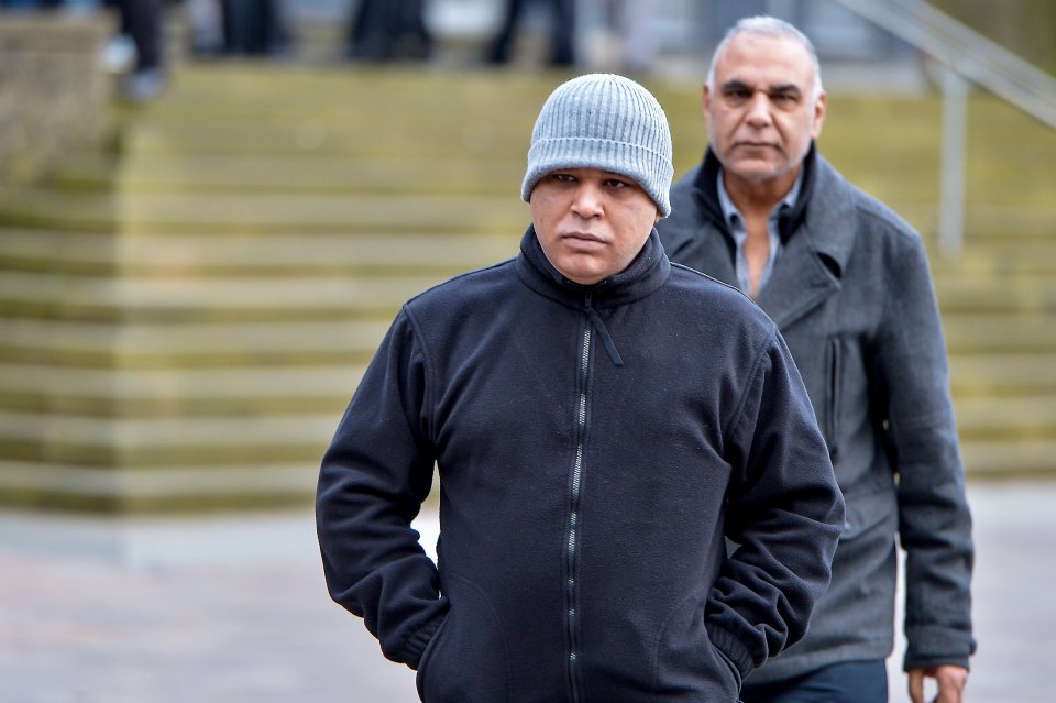 Shazad Nazir (grey hat foreground) leaving Bradford Magistrates' Court in January 2020. He has now been found guilty of rape and sentenced to 11 years in prison