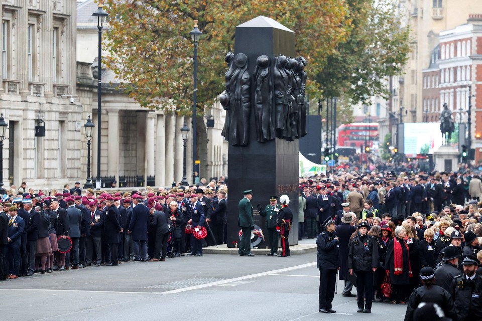 People gather around the Monument to the Women of World War II