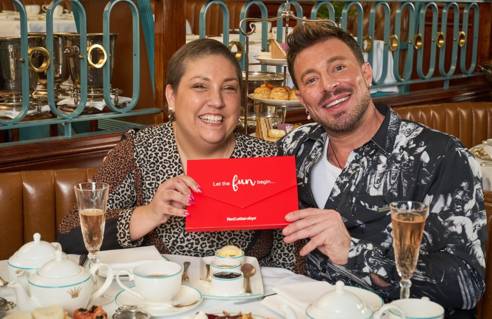 a man and woman holding a red envelope that says let the fun begin