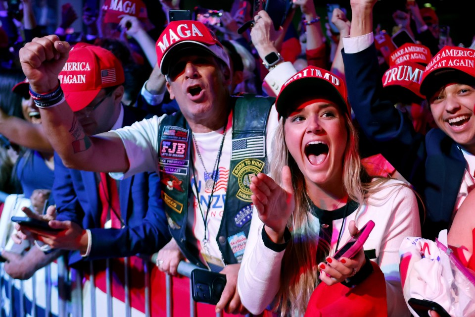 Trump supporters cheer at the Florida convention centre as they wait for him to appear